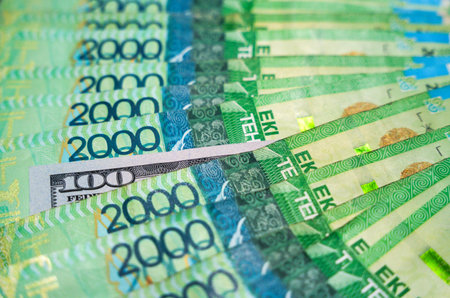 100 dollars among 2000 tenge bills. Paper money from circulationの写真素材