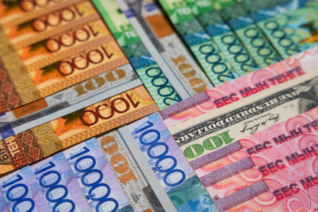 Dollars between large tenge bills. Currency exchange