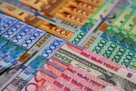 Different tenge bills intertwined with dollars. Currency exchangeの写真素材