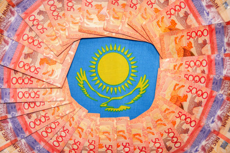 Symbols of the Kazakh flag among large tenge banknotes. State funding