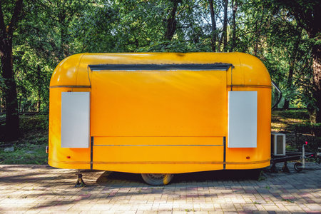 A closed yellow food truck. Business on wheelsの写真素材