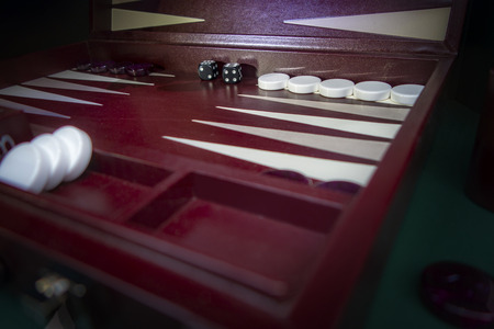 maroon, white and black backgammon board game set