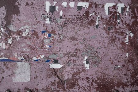 grungy distressed redish background with ripped poster paper and chippingの写真素材