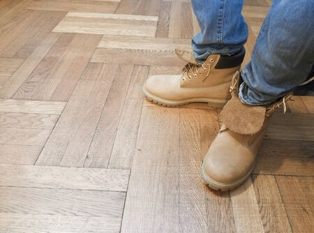 feet blue jeans hard wood flooringの写真素材