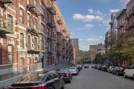 Row historic red brick buildings on one of the iconic streets in a neighborhood of New York City