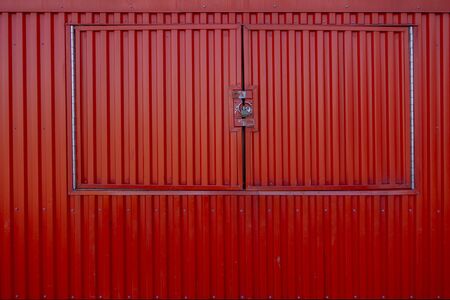 red vertical metal siding body of serving station windows locked and closedの写真素材