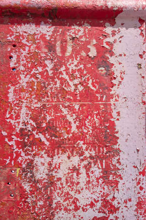 Red painted surface metal distresed peeling background