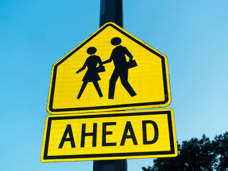 sign icon of man and woman walking and word reading aheadの写真素材