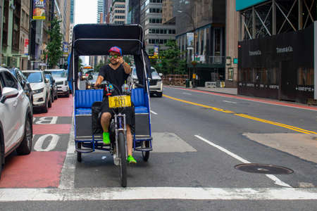 New York, NY  USA 01-30-20: pointing driver of a peddling tax cab in urban city street sayのeditorial素材