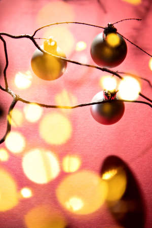 Warm Christmas atmosphere with lights, wood, pine cones and soft shadows in a colorful environment.の写真素材