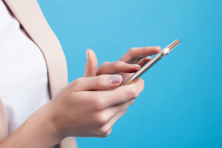 Female hands with phone close-up. Business conceptの写真素材
