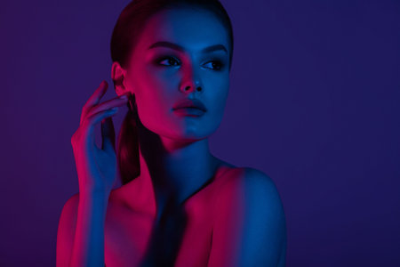 Woman on pink blue neon background. beauty. neon. make up.