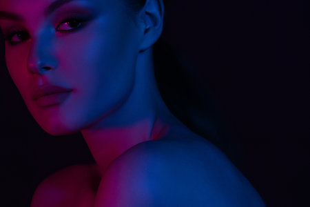 Woman on pink blue neon background. beauty. neon. make up.