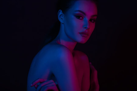Woman on pink blue neon background. beauty. neon. make up.の写真素材