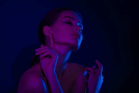 Woman on pink blue neon background. beauty. neon. make up.の写真素材