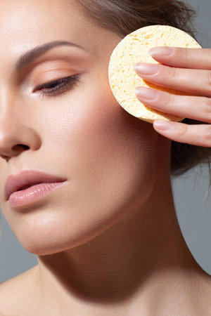 Removing makeup with cotton sponge. Makeup and skincare. Perfect and Beautyの写真素材