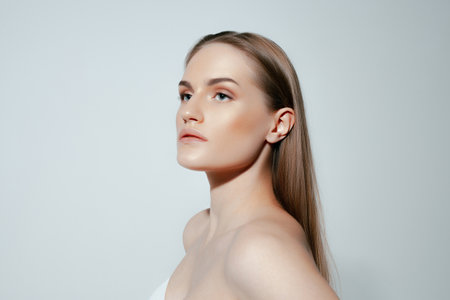 Beautiful caucasian girl with perfect skin and natural makeup on gray background. beauty and skin careの写真素材