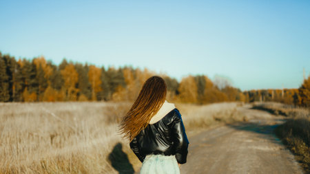 Woman is hitchhiking on background of road. Travelの写真素材