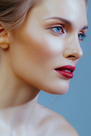 Adult white woman with perfect skin and red lips in close-up. Skin care and makeupの写真素材