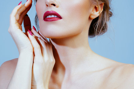 Young woman with red lips and fingernails closeup. Anonymous portraitの写真素材