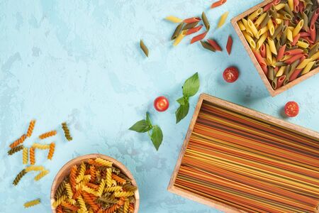 Pasta assorti on blue background with boxの写真素材