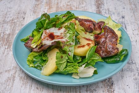 chicken kidney warm salad with greens and avocadoの写真素材