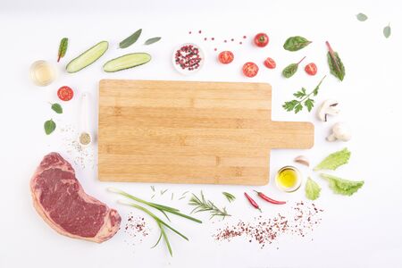 steak on white board with vegetables and spicesの写真素材