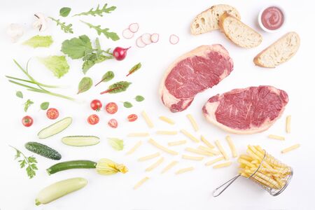 steak on white board with vegetables and spicesの写真素材