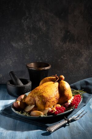 whole chicken on plate with forkの写真素材