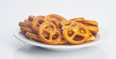 salted cookies on plate on white isolatedの写真素材