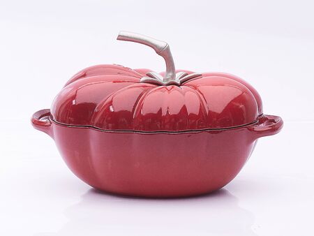 Red pumpkin-shaped saucepan isolatedの写真素材