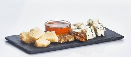 parmesan, blue cheese, walnut and honey on plate isolatedの写真素材