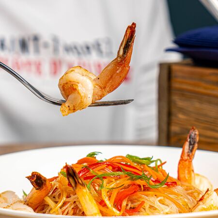 shrimp on fork with noodles with vegetablesの写真素材