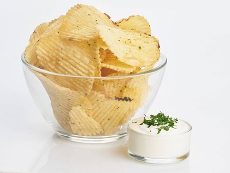 chips in transparent plate with white sauce on white isolatedの写真素材