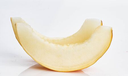 two melon slices on white isolatedの写真素材
