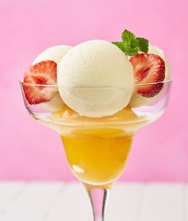 icecream with strawberries on pink backgroundの写真素材