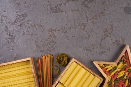 Pasta assorti on gray backgroundwith boxの写真素材