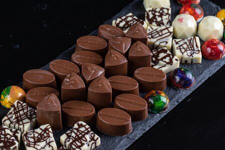 chocolate candies on black stone black background