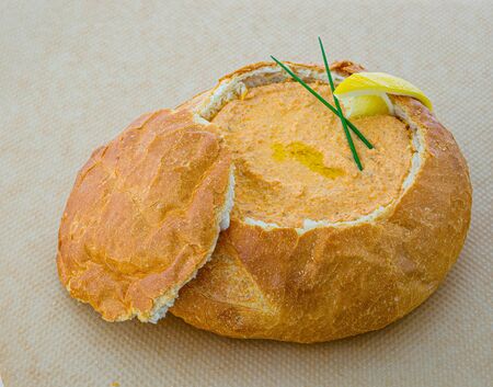 pumpkin soup in bread bowl with cup