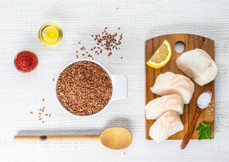 chopped cod on a wooden board on whiteの写真素材