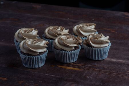 chocolate cupcakes on dark wooden backgroundの写真素材