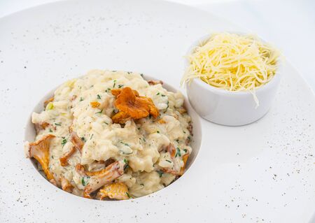 risotto with chanterelles and parmesan on whiteの写真素材