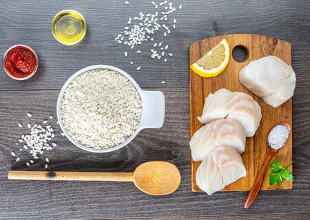 chopped cod on a wooden board on whiteの写真素材