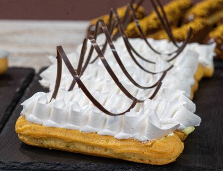 assorted chocolate eclairs with nuts