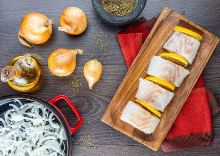 chopped cod on a wooden board on whiteの写真素材