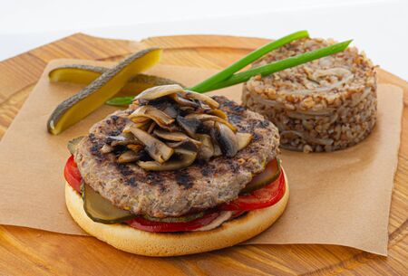 burger with mushrooms and buckwheat on whiteの写真素材