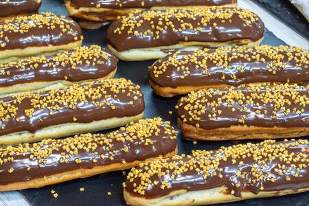 assorted chocolate eclairs with nutsの写真素材