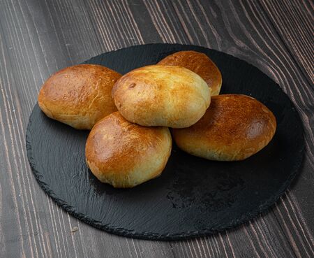 pies on a black plate on tableの写真素材