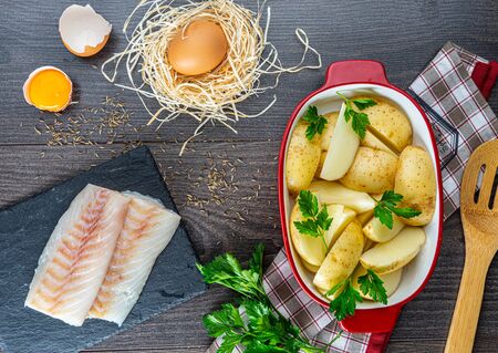 chopped cod on a wooden board on whiteの写真素材