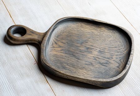 handmade dark wooden tray on whiteの写真素材